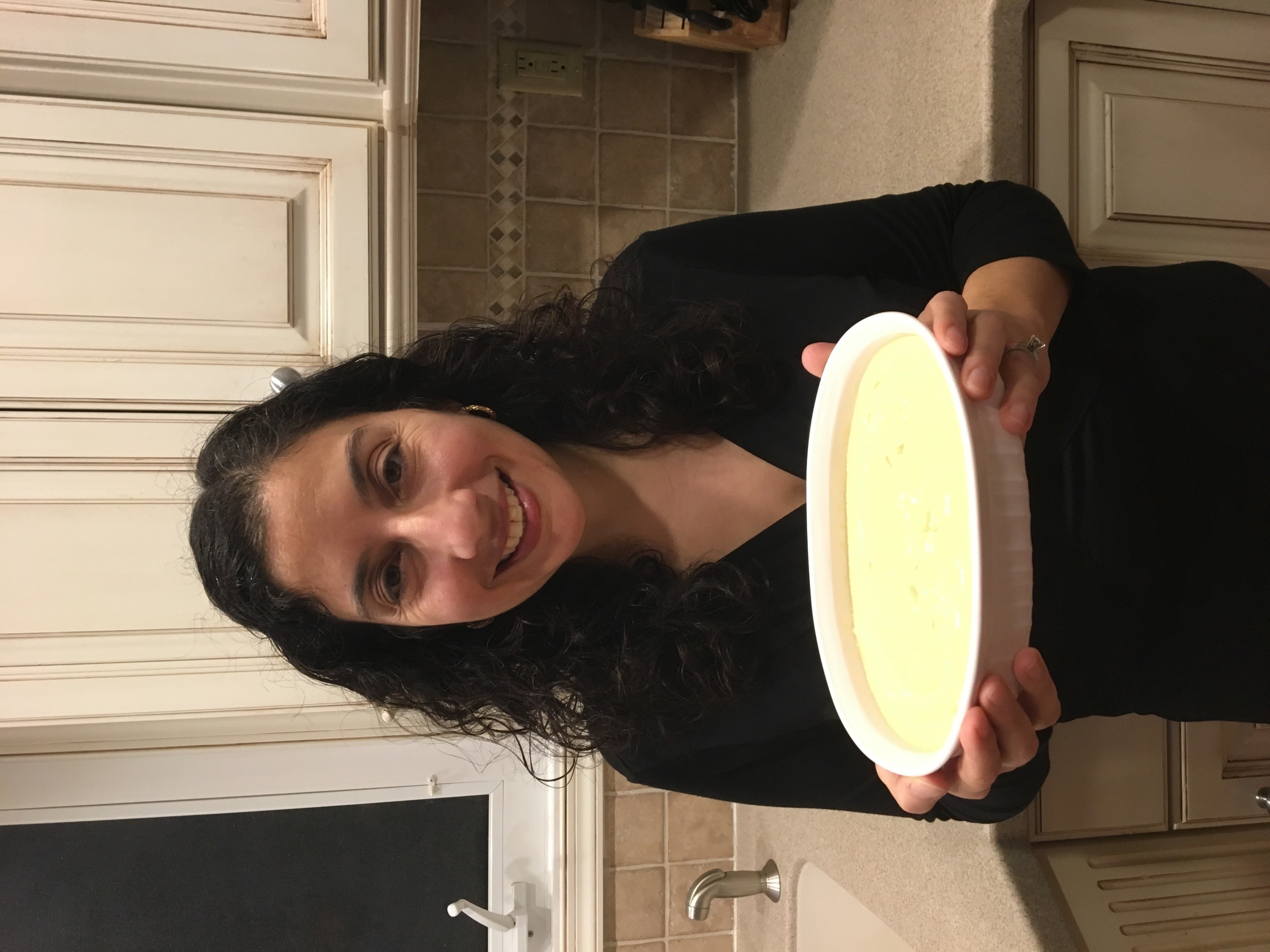 Author Tina Gabrielle holding a dish of her delicious homemade hummus
