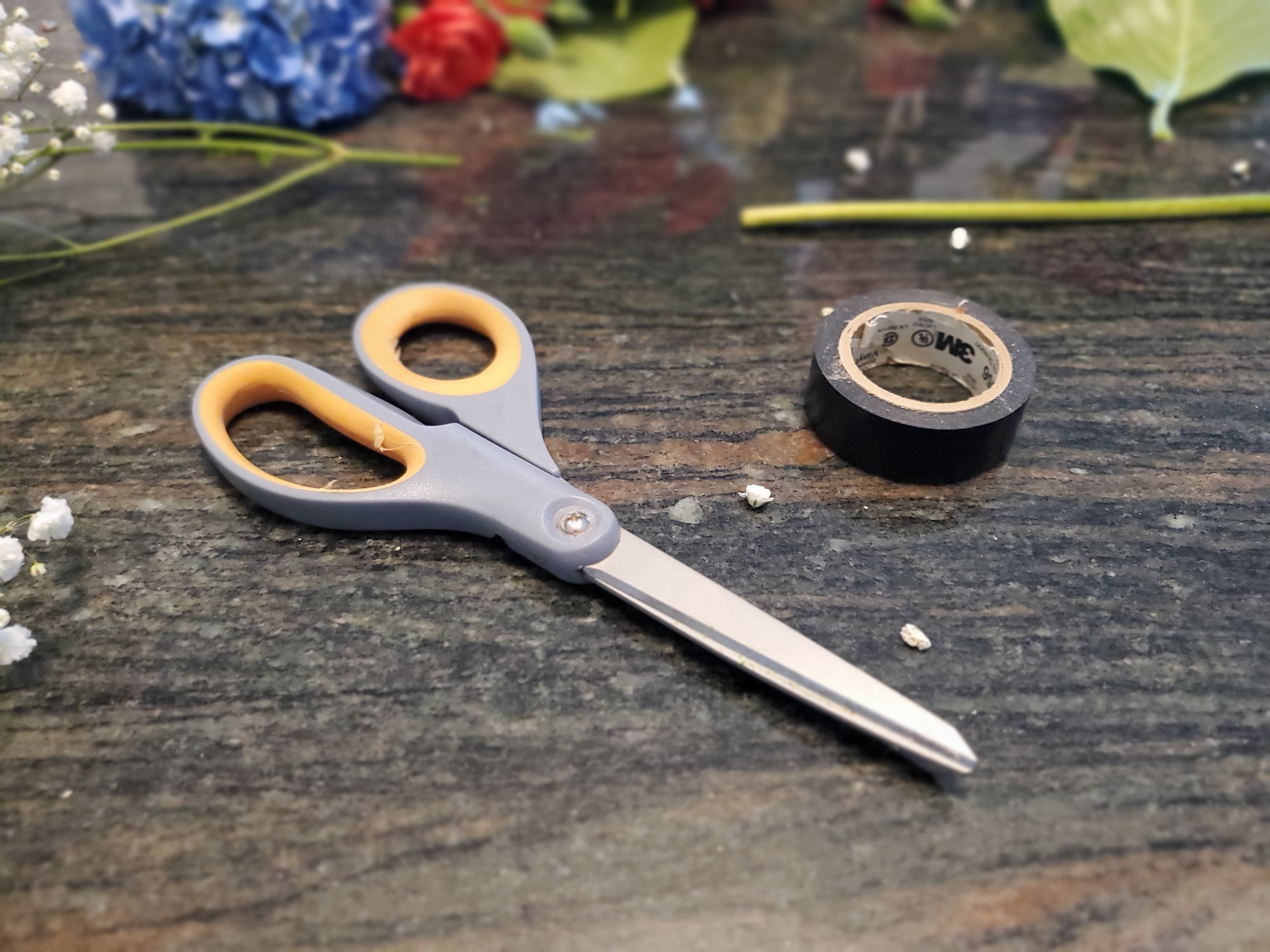 A pair of scissors and some floral tape
