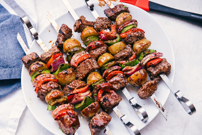 A plate of grilled meat and vegetable skewers